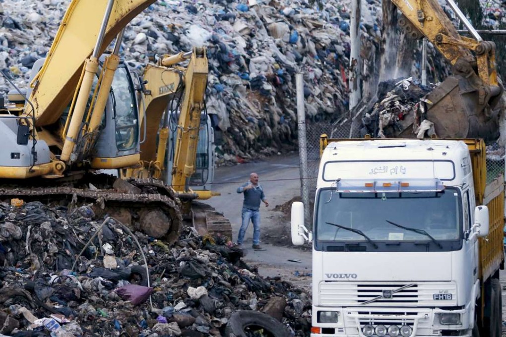 Workers in Beirut use a front-loader to move garbage to Naameh landfill. Photo: Reuters