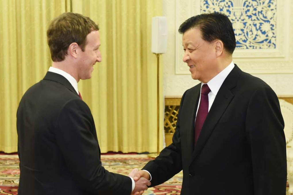 Liu Yunshan, right, greets Mark Zuckerberg in Beijing. Photo: Xinhua