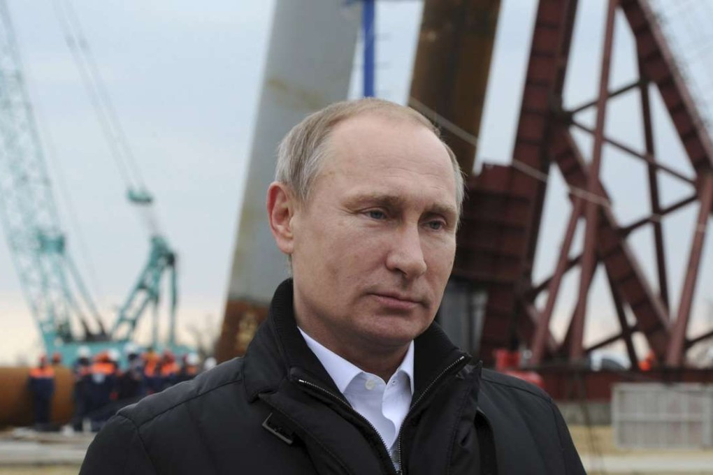 Russian President Vladimir Putin visits the construction site of a bridge linking Crimea and Russia, across the Kerch Strait on Tuzla Island on Friday. Photo: Reuters