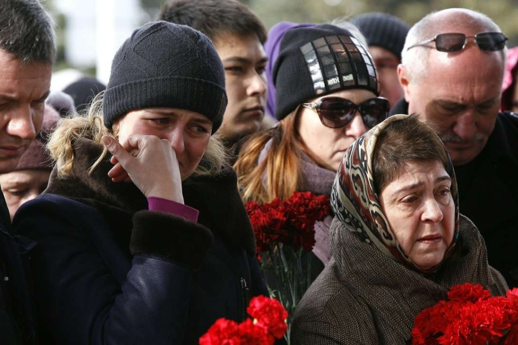 Mourners pay a tribute to the 62 victims of Saturday’s air crash at the Rostov-on-Don airport entrance in Russia. Photo: AFP