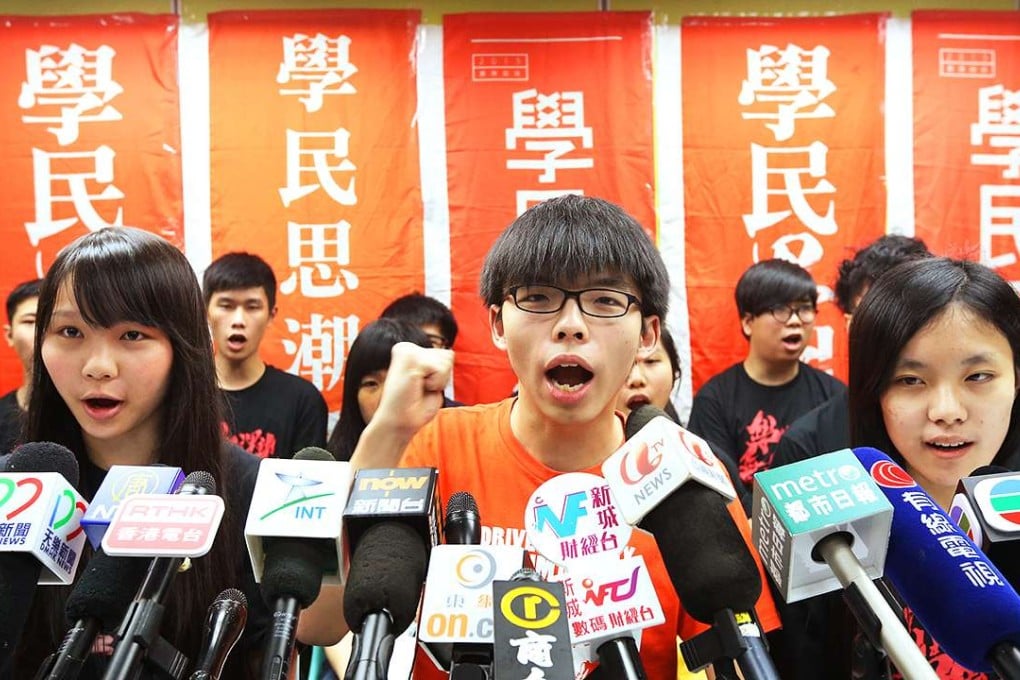 Joshua Wong (centre) sets out what will happen to student group Scholarism. Photo: Felix Wong