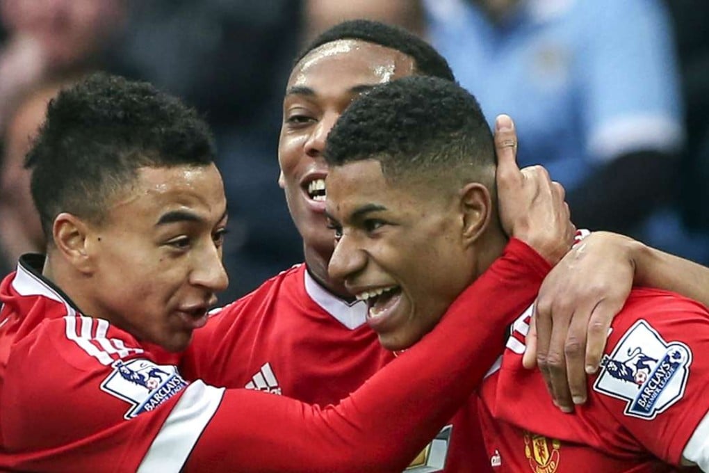 Manchester United’s match-winner Marcus Rashford celebrates with teammates after his goal against Manchester City. Photo: EPA