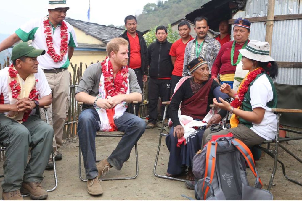 Harry sitting next to Mangali Tamang, 88, wife of late Gandu Tamang who was with the British Gurkha troops during the second world war. Photo: Reuters