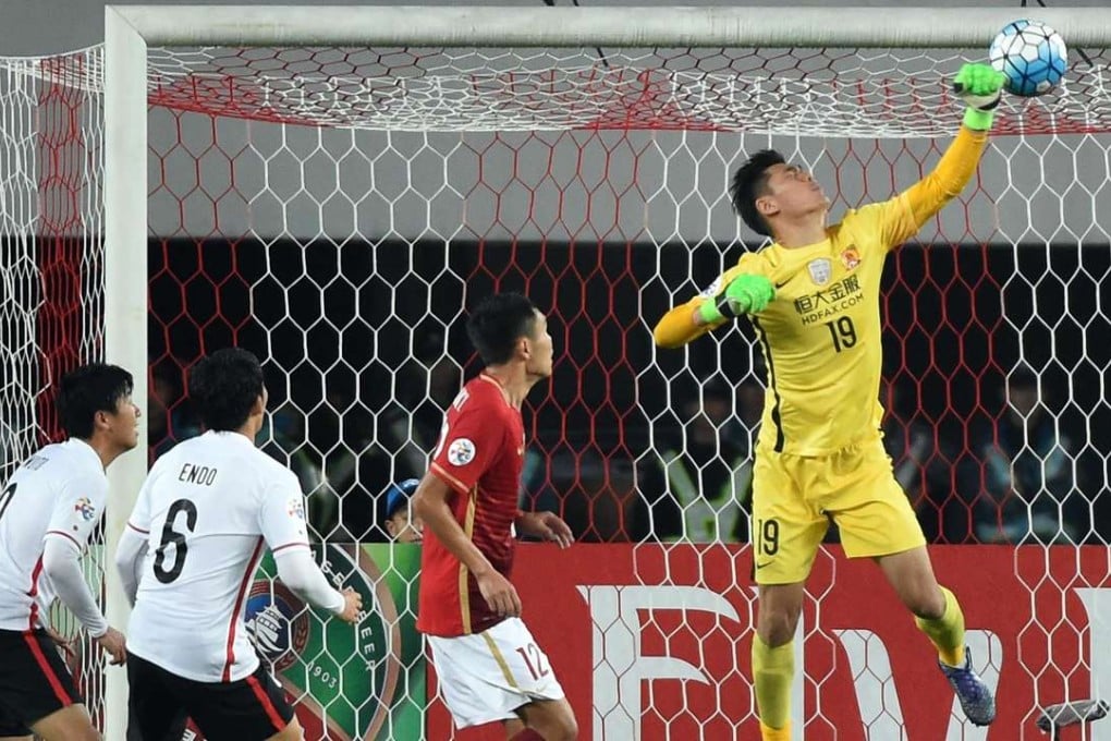 Guangzhou Evergrande’s Zeng Cheng makes a save against Japan’s Urawa Red Diamonds in the AFC Champions League on an otherwise bad night. Photo: Xinhua