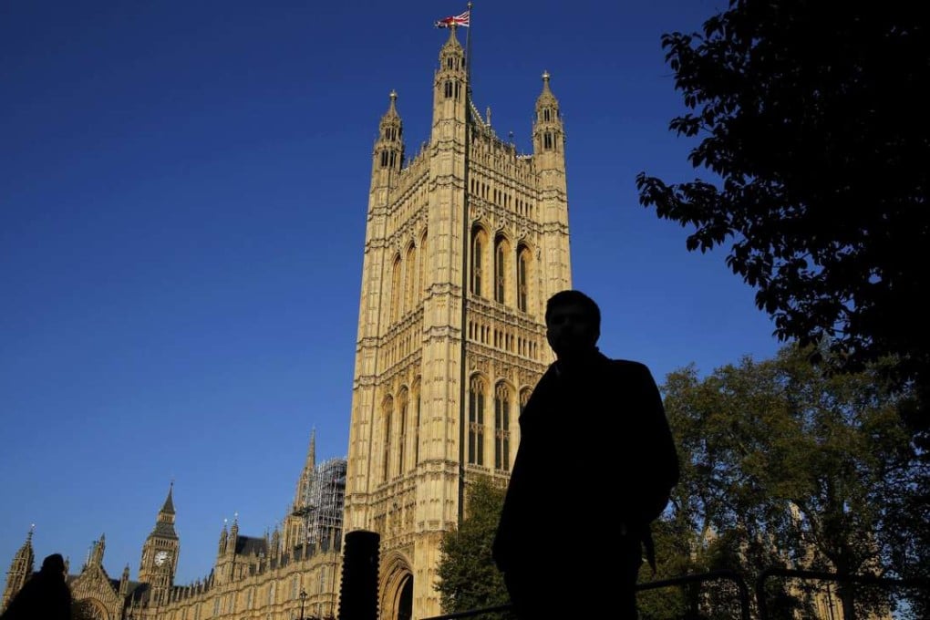 People are silhouetted against the Houses of Parliament in central London. Photo: Reuters