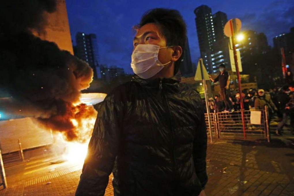 Smoke rises as rioters start fires on a street in Mong Kok district of Hong Kong on February 9 this year. Photo: AP