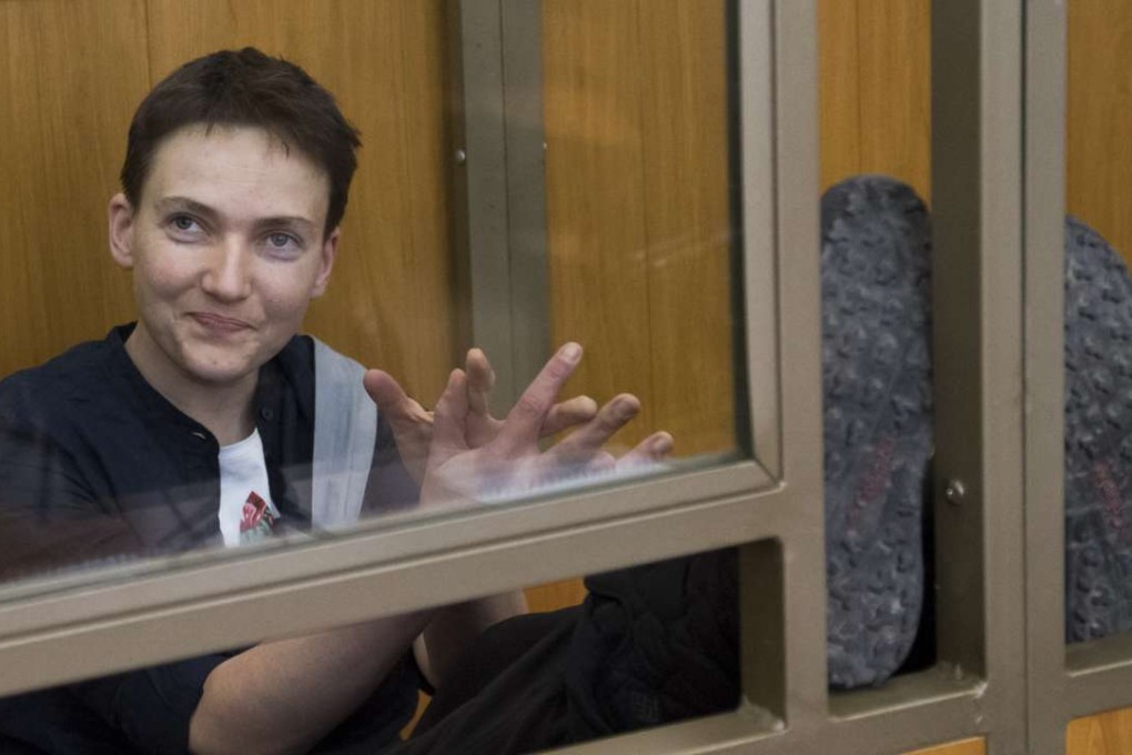 Ukrainian pilot Nadiya Savchenko smiles in a glass cage inside court in the town of Donetsk, Russia, on Tuesday. Photo: AP