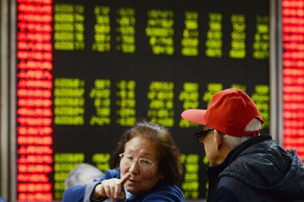 Investors talk while seated in front of an electronic stock exchange board at a securities firm in Beijing in this photo dated on February 29, 2016. Photo: Kyodo