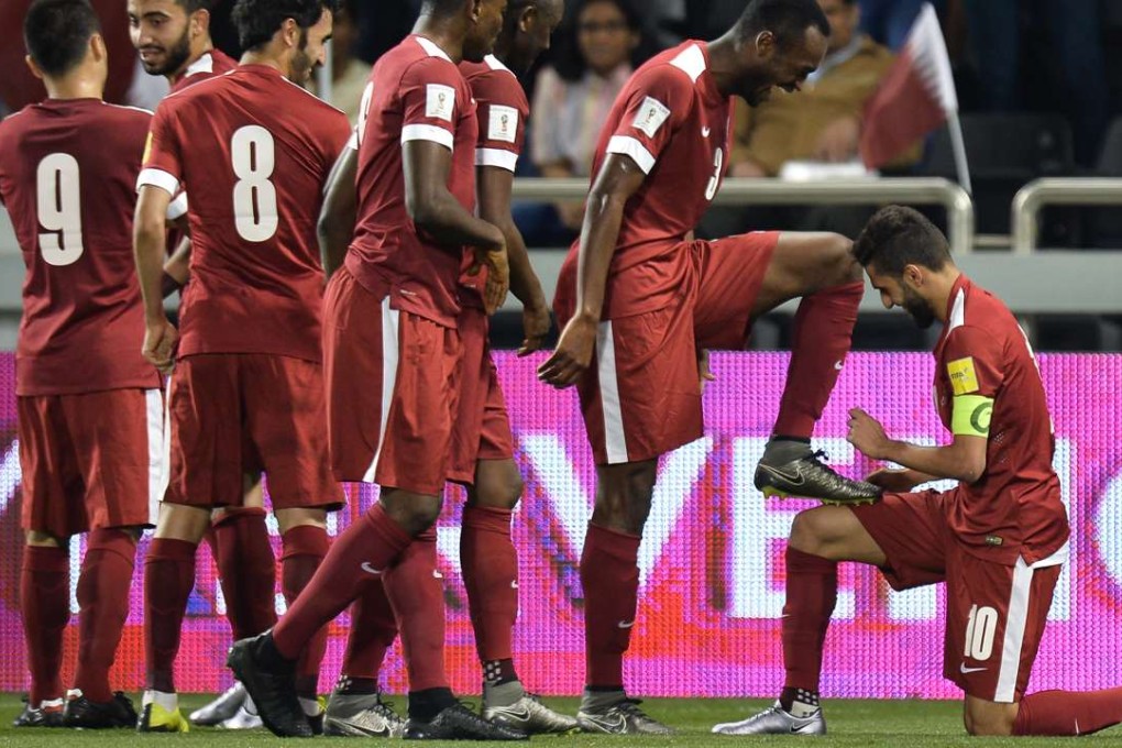 Qatar's Hassan Al Haidous (right) celebrates with teammates after scoring the opener against Hong Kong. Photo: Xinhua