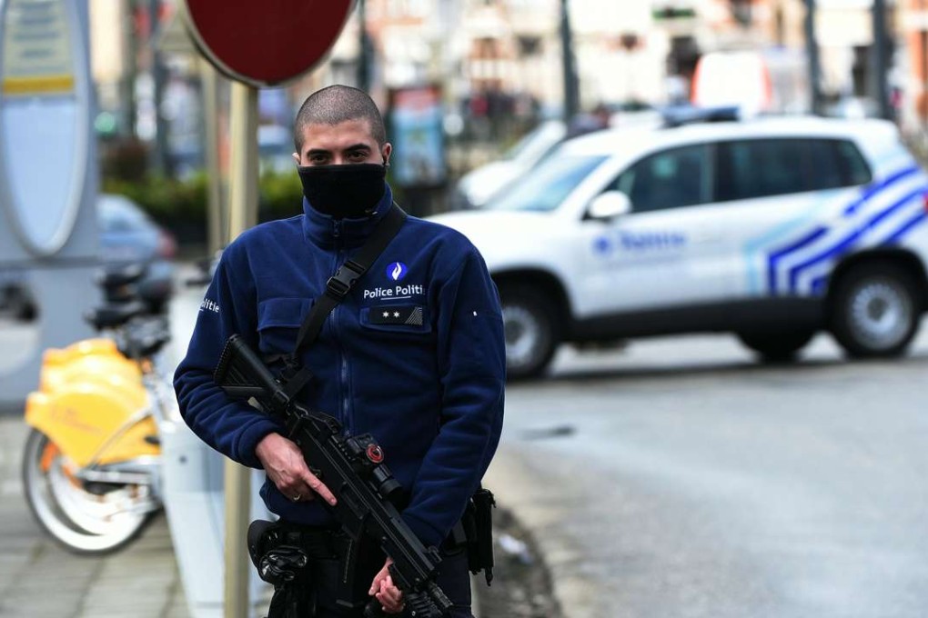 A police officer patrols in the Schaerbeek district of Brussels a fresh anti-terrorist operation. Photo: AFP