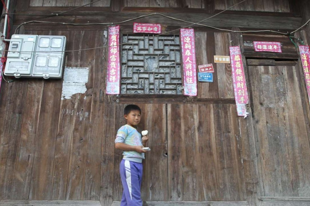 Xiong, 8, is a third grade pupil whose father is a migrant worker and leaves him living with his grandmother in a village in Weng’an county, southwest China’s Guizhou province. Almost all children in the village are left-behind children. Photo: Simon Song