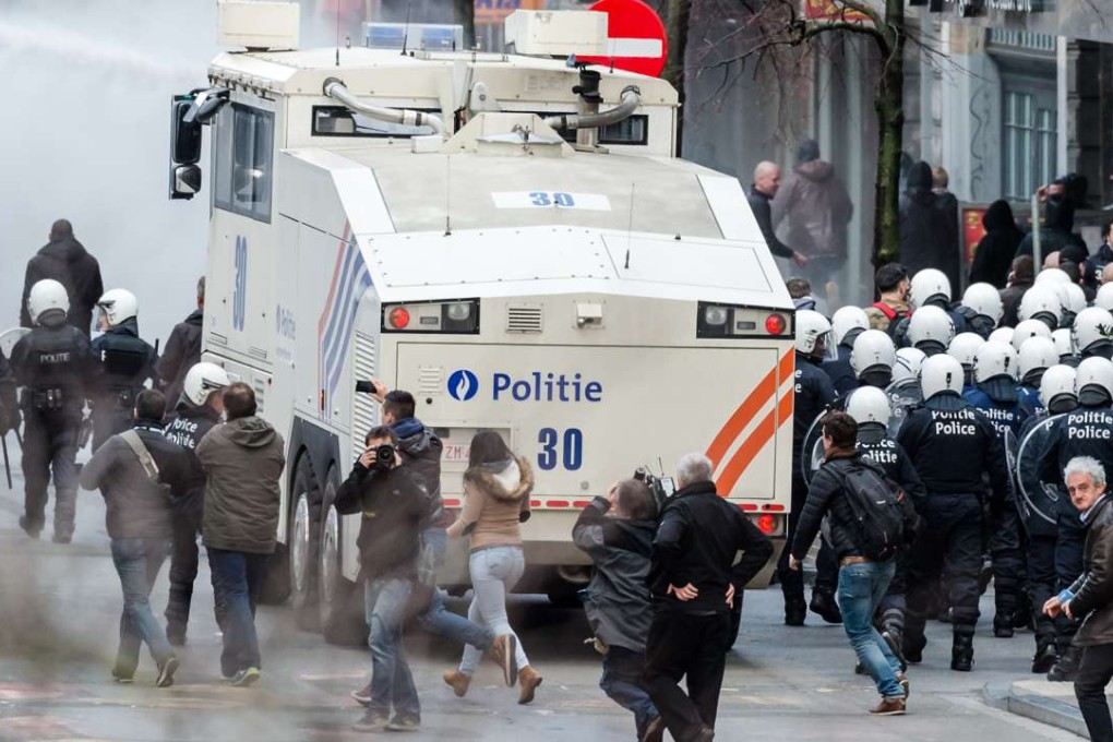 Police use a water cannon as far-right demonstrators protest at a memorial in Brussels. Photo: AP