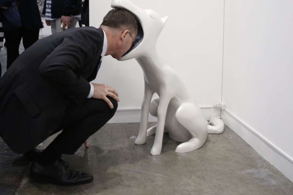 A visitor to Art Basel interacts with art installation ‘Face To Face’ by Taiwan artist Peng Hung-chih. Photo: AP