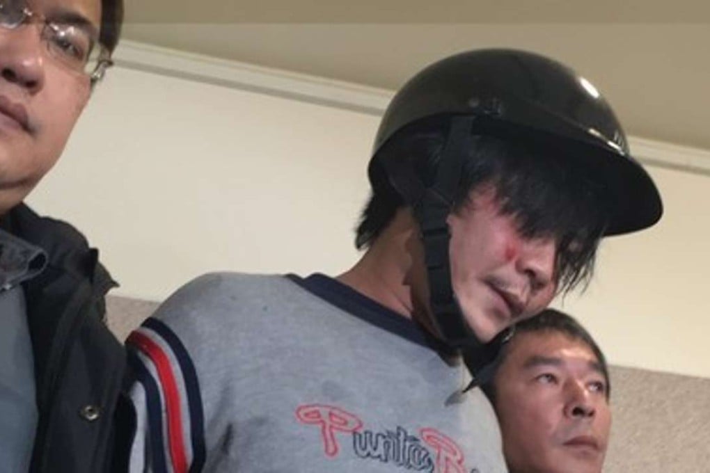 The suspect, Wang Ching-yu, 33, is escorted by police after the gruesome incident that took place in Taipei’s Neihu district in Taiwan on Monday. Photo: SCMP Pictures