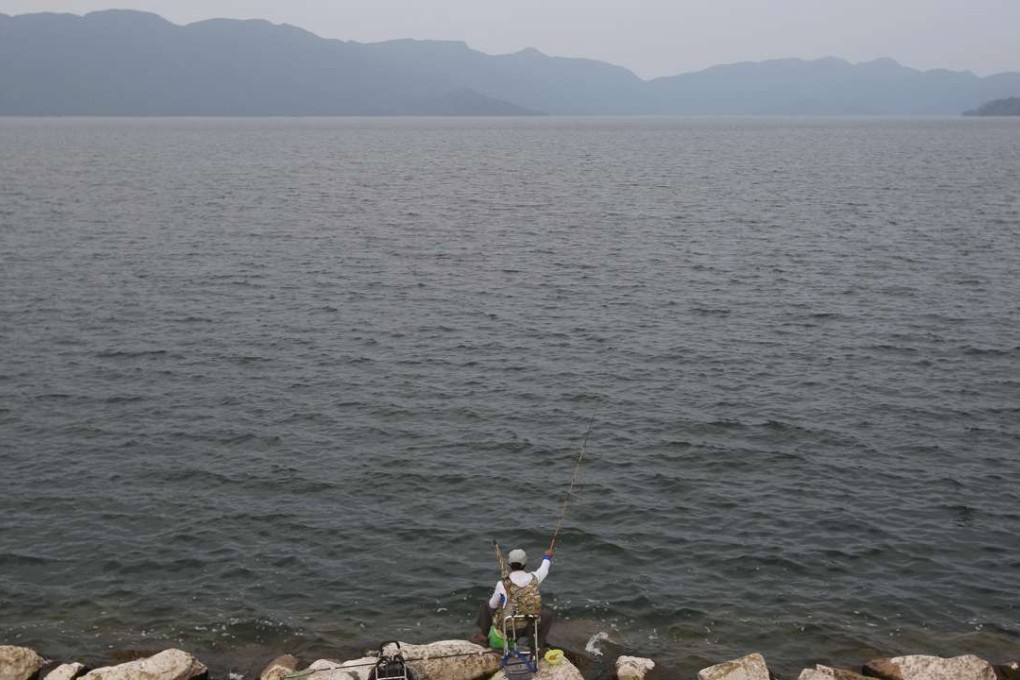 A man fishes at Plover Cove Reservoir in northeast Hong Kong. Photo: Sam Tsang