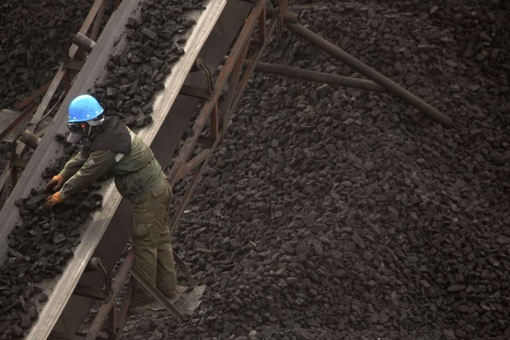 s worker monitors coal being carried along conveyor ramps at a coal mine. Photo AP