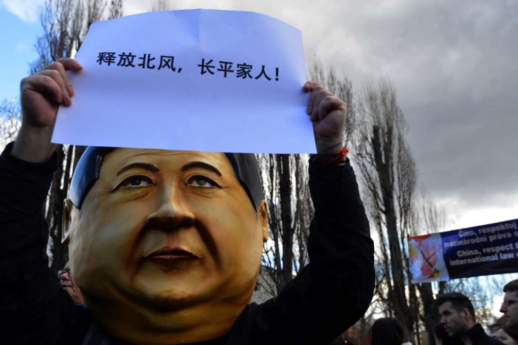 A demonstrator with a mask of Chinese President Xi Jinping's likeness and a poster reading “release Bei Feng and Chang Ping's relatives” in Prague, Czech Republic, where Xi is visiting. Photo: AFP