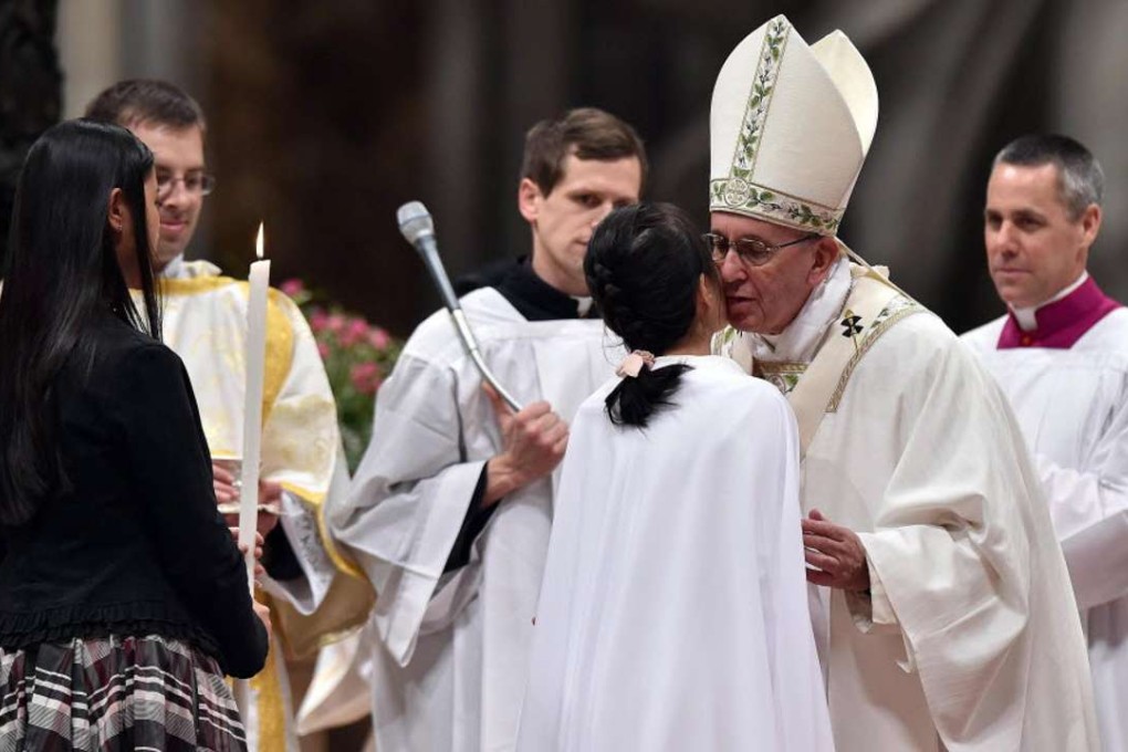 Pope Francis baptises Mary Stella Li Zhang of China during the 2016 Easter Vigil mass at Saint Peter’s Basilica in Vatican City. Photo: EPA