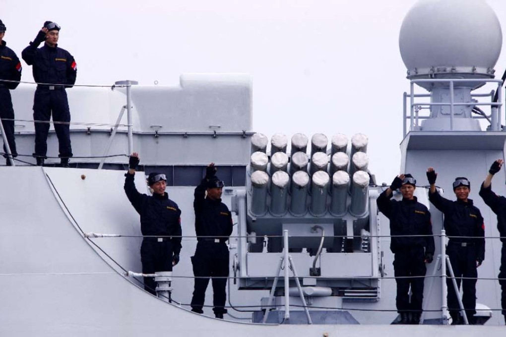 Chinese Navy special forces wave to onlookers in Sanya, southern China, before heading to waters off Somalia for an escort mission against piracy. Photo: Xinhua
