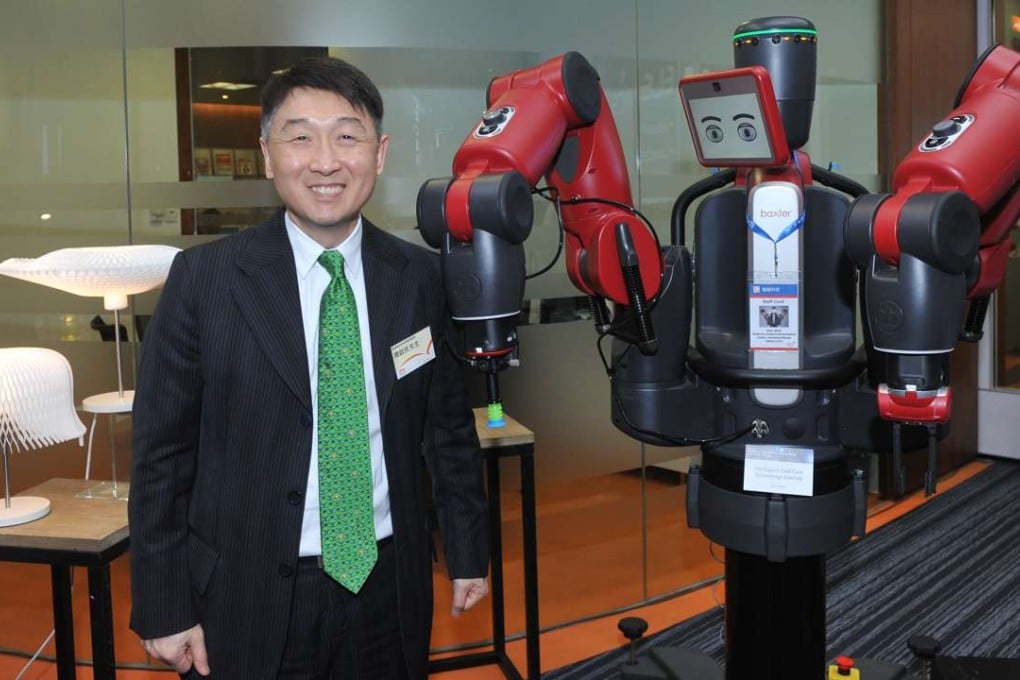 Benjamin Chau, acting executive director of the Hong Kong Trade Development Council, poses next to Baxtor, a robot created by Hong Kong’s Intelligent Cad Cam Technology. Photo: HKTDC