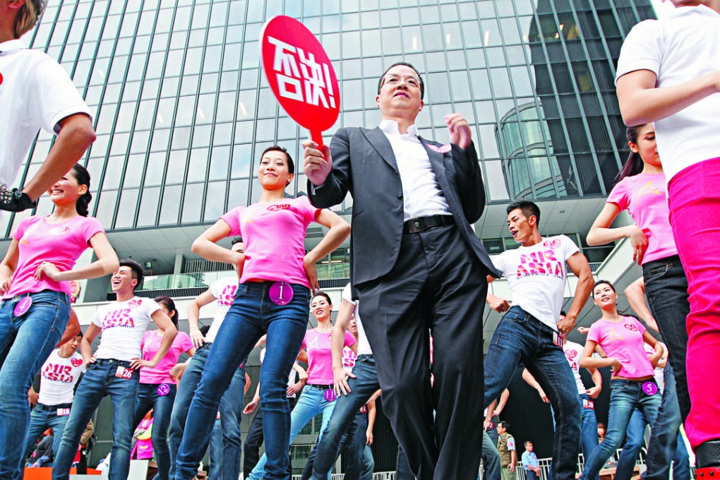 Mainland businessman Wong Ching shows off his dance moves outside the government headquarters. Critics say he is a major reason ATV died. Photo: Felix Wong