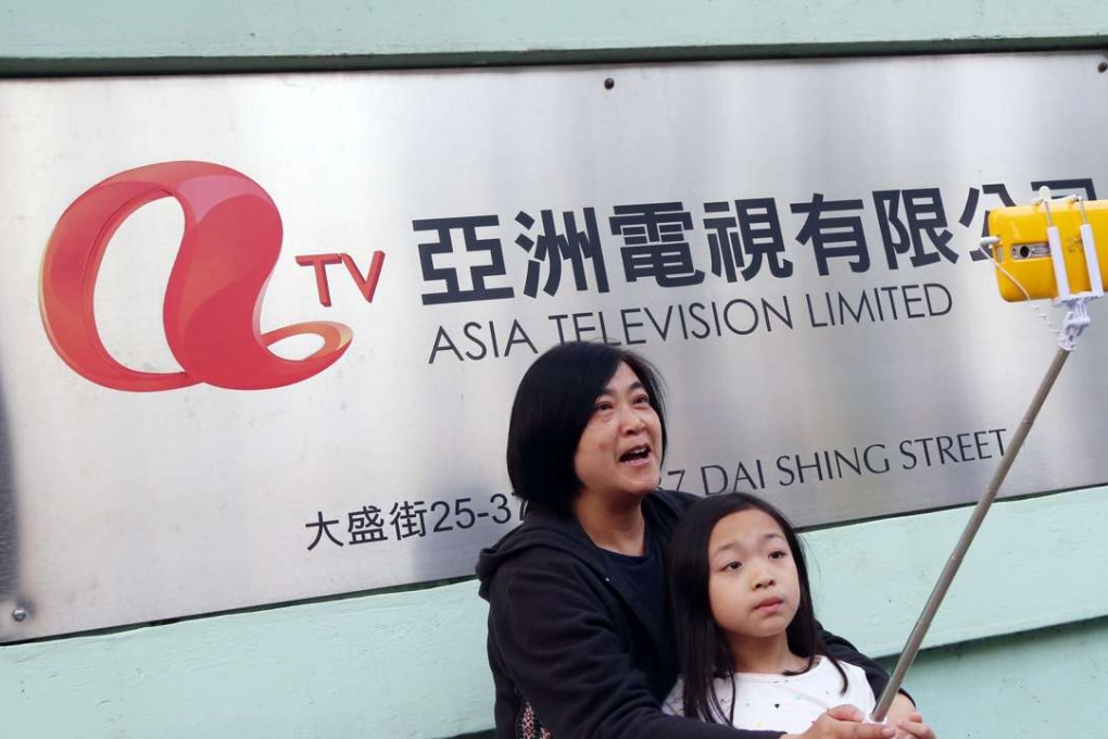 A woman takes a selfie outside the ATV headquarters in Tai Po hours before the 59-year-old broadcaster went off air. Photo: David Wong