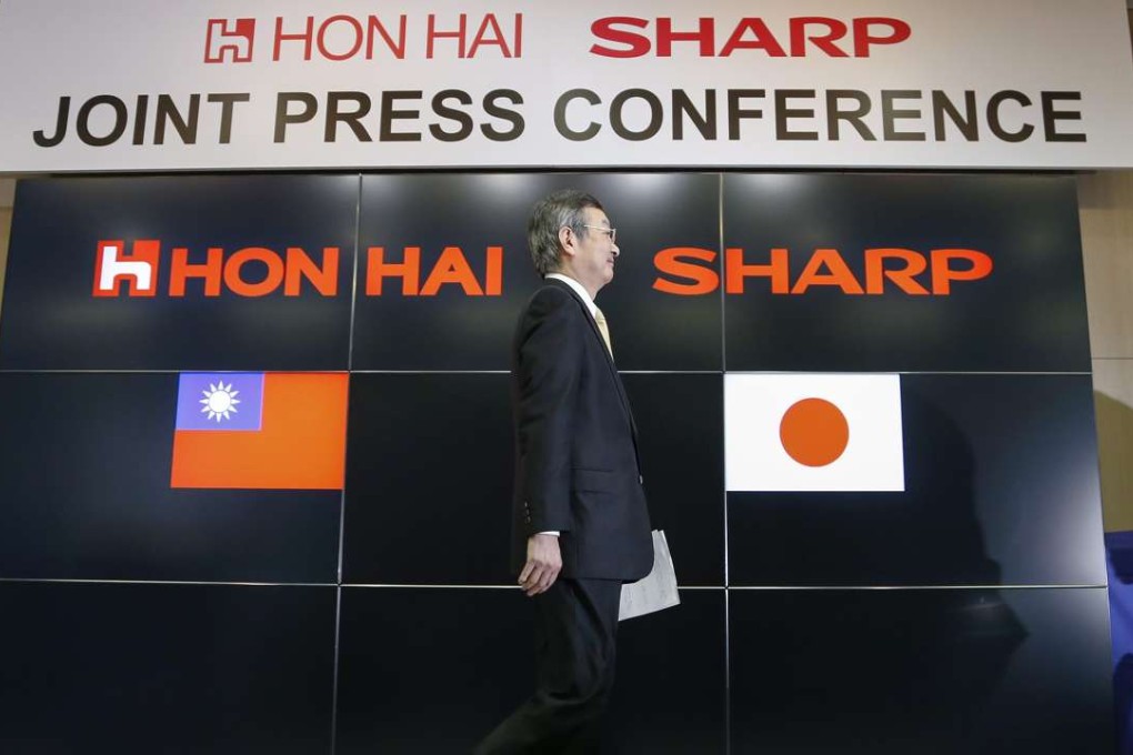 Kozo Takahashi, president of Sharp Corp, walks past a podium after speaking following a takeover agreement with Taiwan's Hon Hai Technology Group in Osaka. Photo: EPA