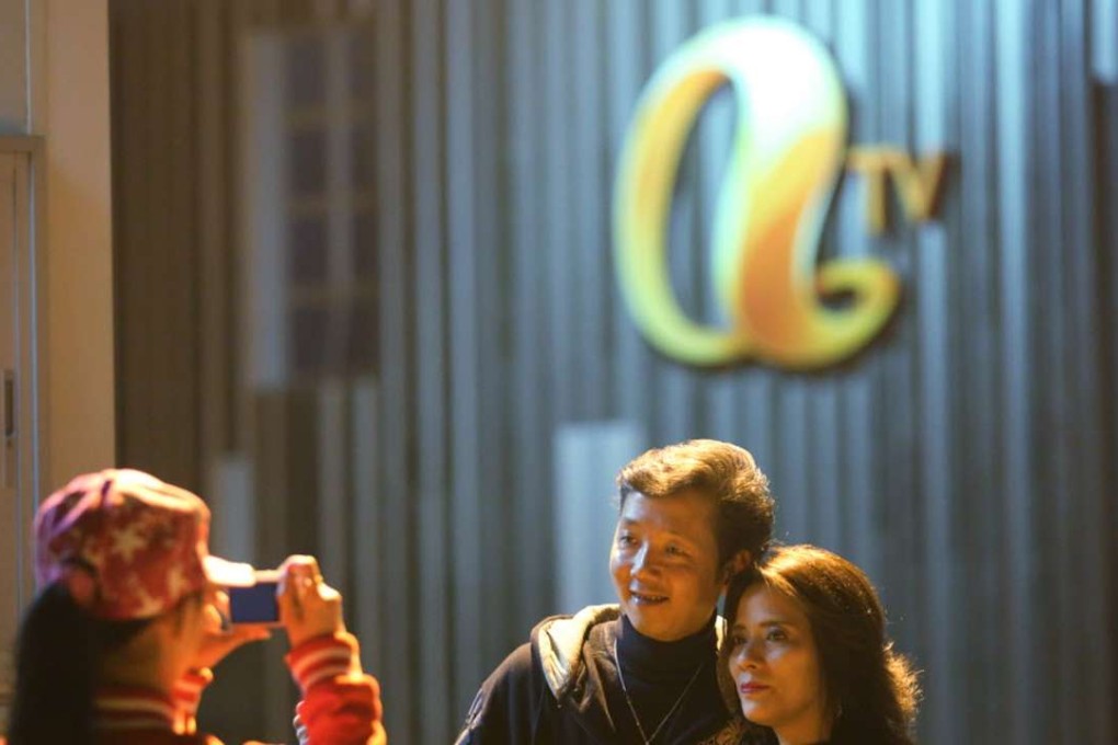 Fans take souvenir photos outside ATV’s headquarters in Tai Po. Photo: Edward Wong