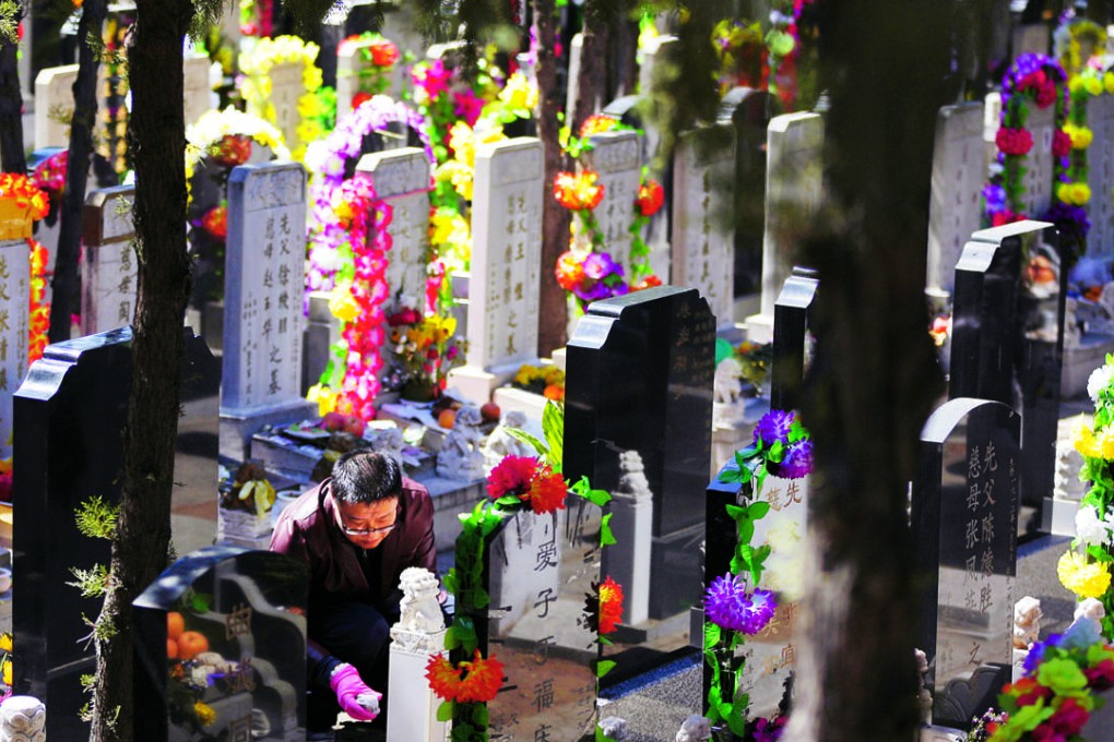 A man cleans a tomb at the Babaoshan cemetery during the Ching Ming, or Tomb Sweeping, festival. Chinese around the world mark the day by remembering their dearly departed, cleaning their tombstones and placing flowers and offerings. Photo: AP