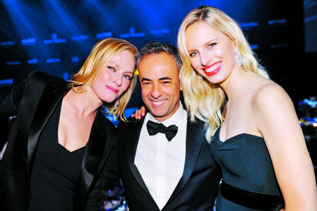Francisco Costa with actress Uma Thurman (left) and model Karolina Kurkova at the AmFar gala in Hong Kong.