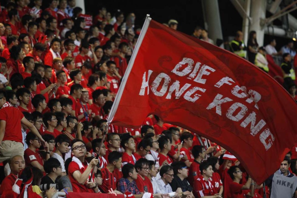A Hong Kong football fan waves a flag during a world cup qualifier at Mong Kok Stadium last year. Hong Kong fans booed the anthem they share with China while some turned their backs in a show of defiance. Photo: AFP