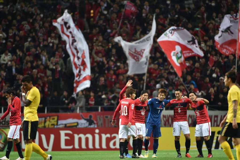 Urawa Reds players celebrate their victory over Guangzhou Evergrande in group H in Saitama. Photo: AP