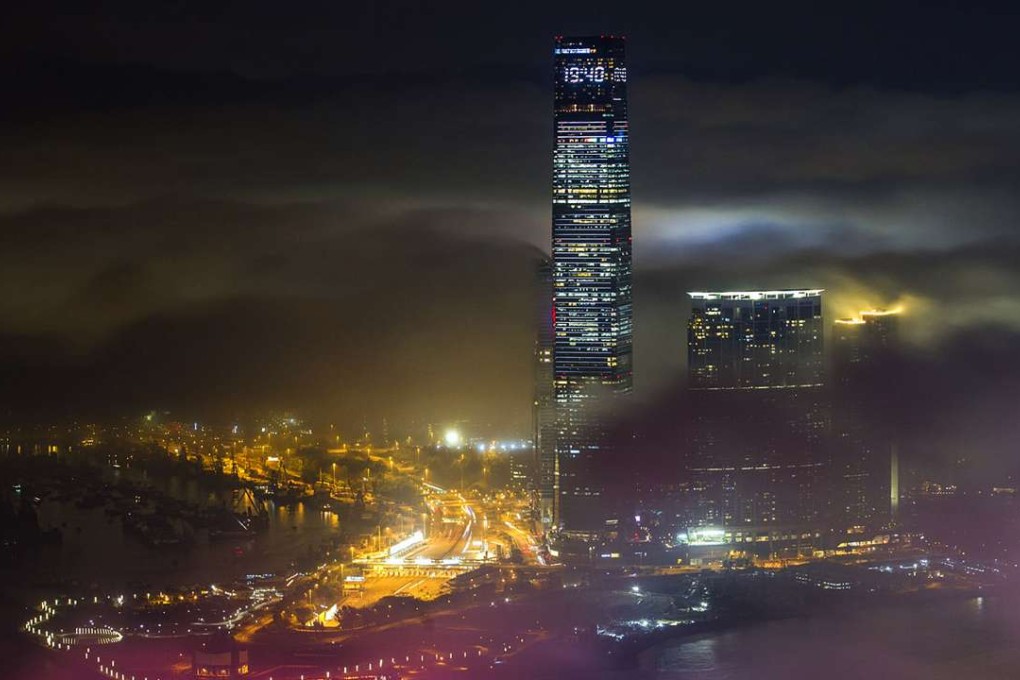 Kowloon’s ICC tower peeks through the fog that hides the rest of the northern part of the city. Photo: Bruce Yan
