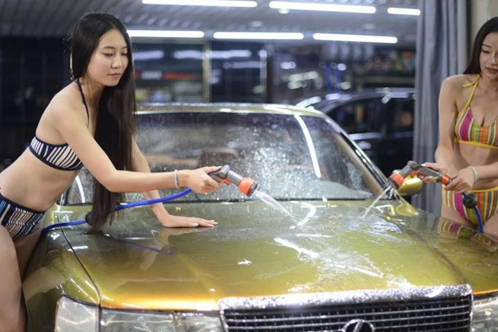 Girls in bikinis wash cars in Taiyuan, the capital of north China’s Shanxi province, in this July 2014 file photo. O2O service providers like Bopai that offer routine car-washing services have been dropping like flies in China since last year. Photo: SCMP Pictures
