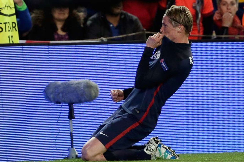 Fernando Torres celebrates scoring the opening goal for Atletico Madrid against Barcelona. His delight was short-lived. Photo: AP