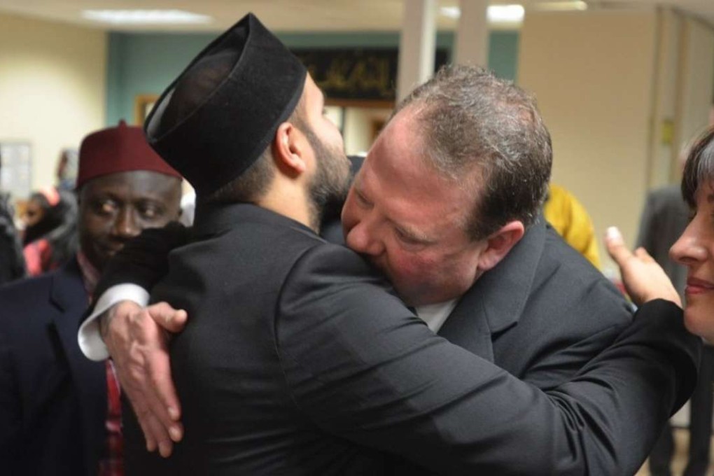 Ted Hakey hugs Zahir Mannan at the Baitul Aman ‘House of Peace’ Mosque. Photo: Washington Post/Hartford Courant