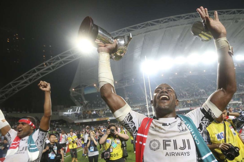 Josaia Raisuqe holds the Hong Kong Sevens Cup aloft after Fiji win the 2015 Rugby Sevens tournament in Hong Kong. Photo: Sam Tsang