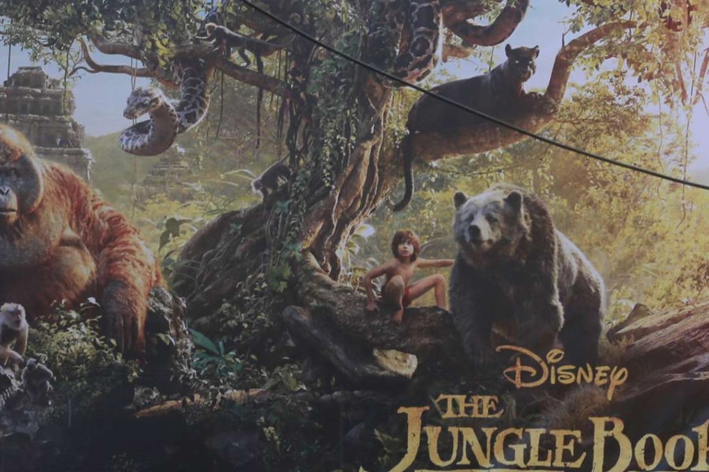 A man drives past a poster of The Jungle Book at a cinema in Mumbai. India's censor board is requiring parents to accompany children under 12 at screenings of the Disney film because the special effects are too scary. Photo: AP
