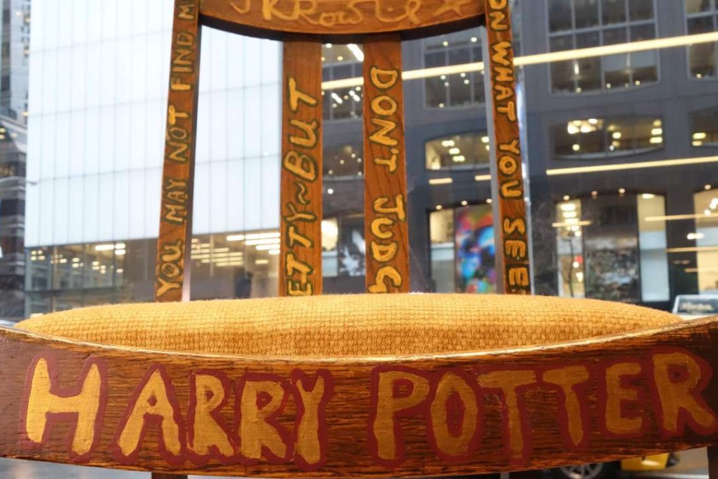 The chair used, and later decorated, by author J.K. Rowling while she wrote the first two Harry Potter books on display alongside a letter of provenance from the author at Heritage Auctions in New York. The chairs were sold at auction in New York. Photo: AFP