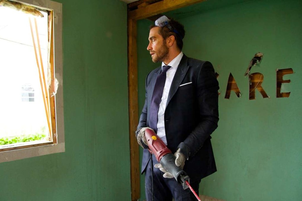 Jake Gyllenhaal, as Davis Mitchell, takes to destroying his home with an imposing tool in a scene from Demolition. Photo: Fox Searchlight