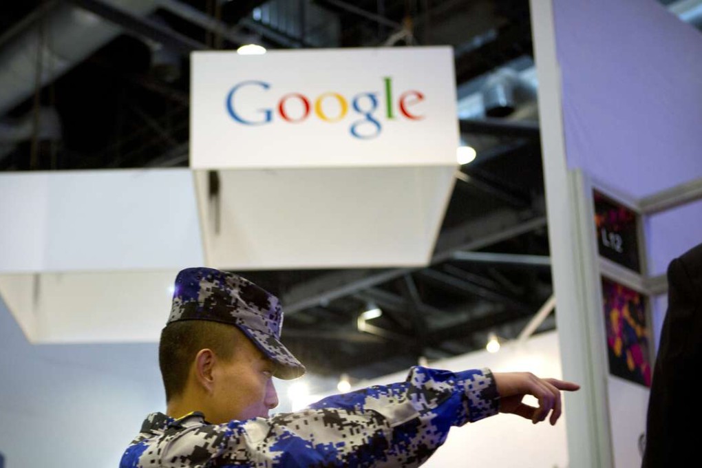 A security guard points while walking past a display booth for Google at the Global Mobile Internet Conference in Beijing in a file photo from April, 2015. Sites like Google and Twitter are banned on the mainland. Photo: AP