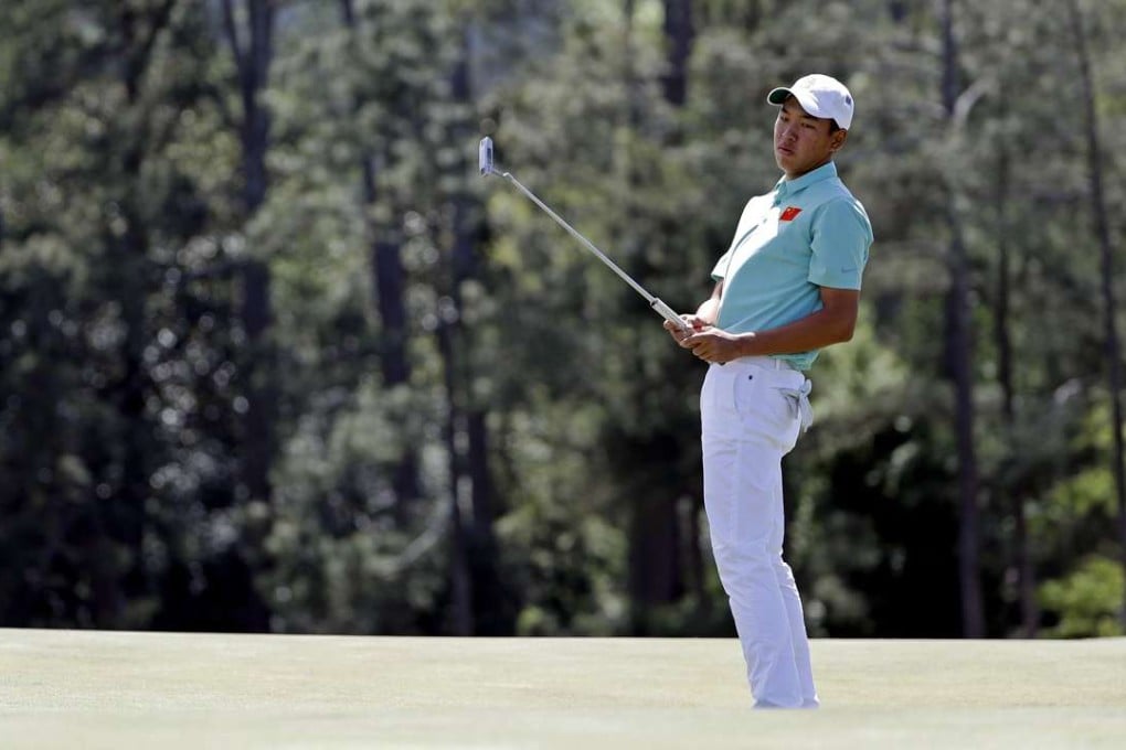 Amateur Jin Cheng follows his putt on the 18th hole during the first round. Photo: AP