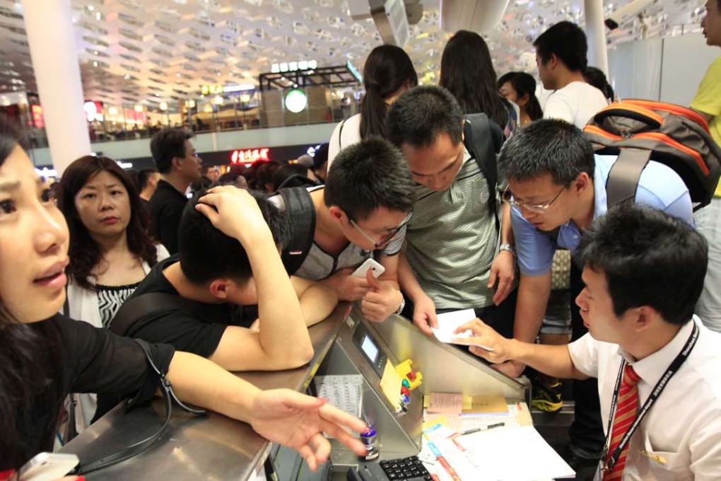 Passengers surround airline staff after their flight is delayed in Shenzhen in south China’s Guangdong province. Photo: SCMP Pictures