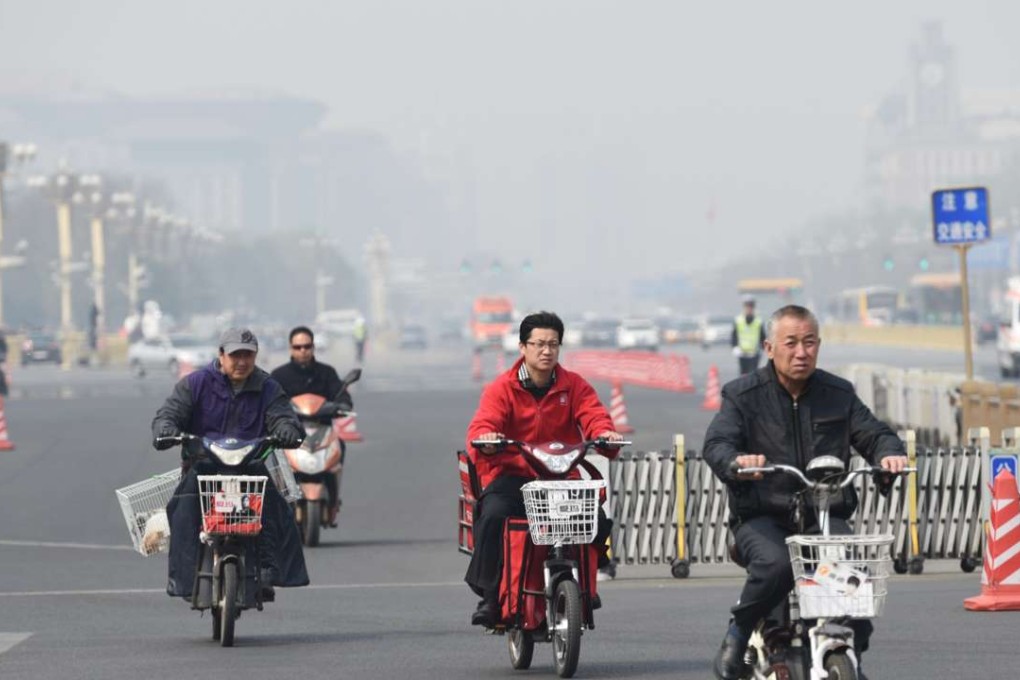 Residents ride electric bikes on Changan Avenue in Beijing. Changan Avenue is one of 10 roads in the city where electric bicycles will be banned starting from April 11. Photo: Xinhua