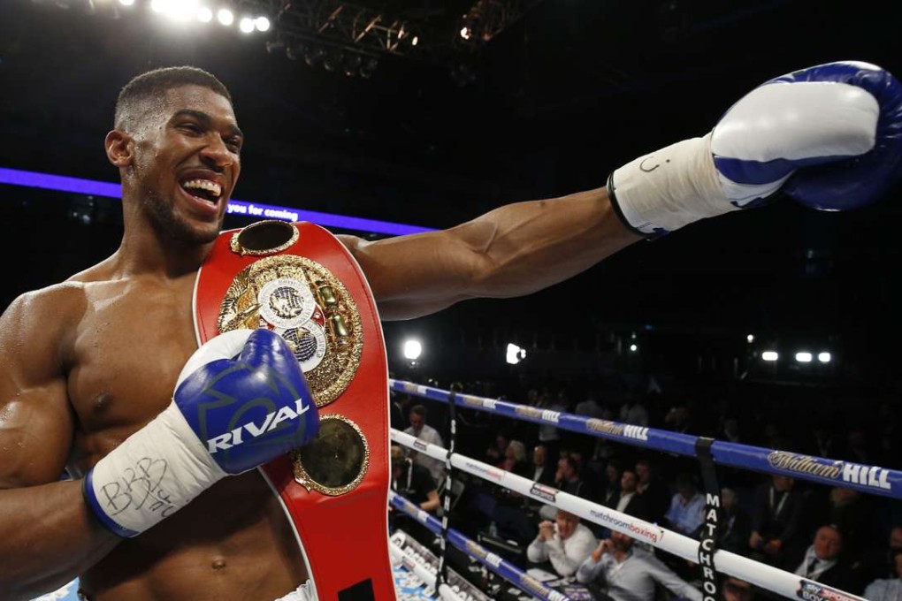Anthony Joshua celebrates with his IBF heavyweight title after crushing Charles Martin in two rounds. Photo: Reuters