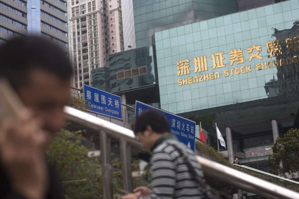 People walk past the Shenzhen Stock Exchange. Photo: EPA