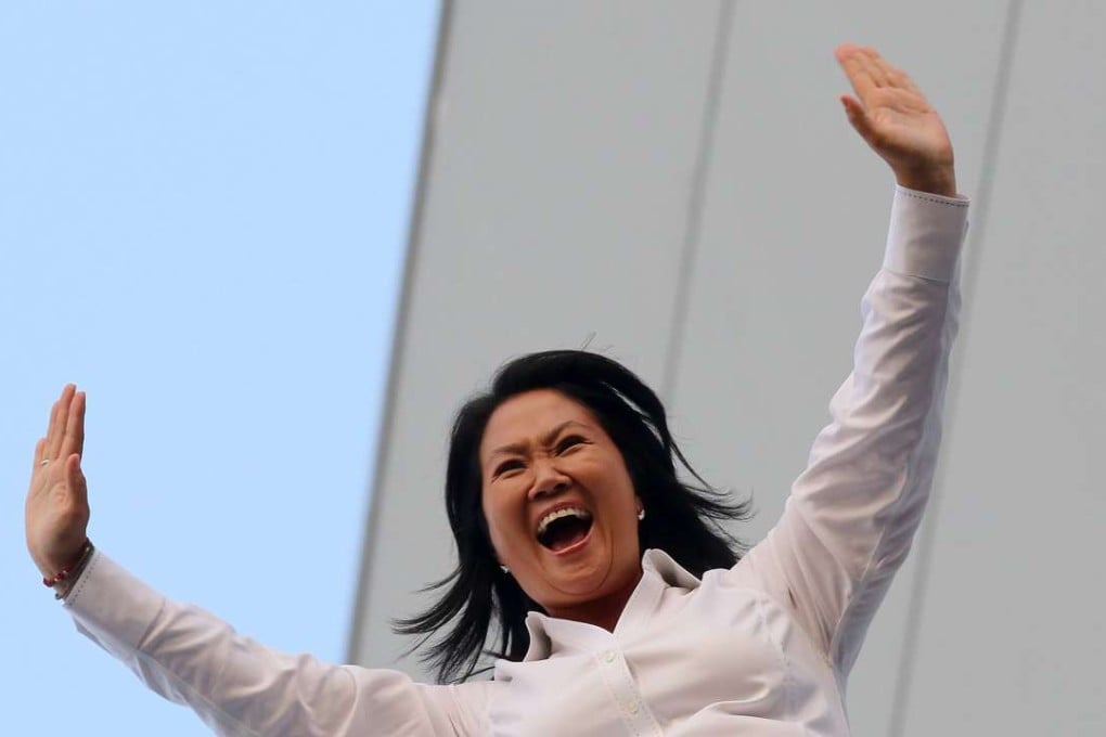 Peruvian presidential candidate Keiko Fujimori of the Popular Force (Fuerza Popular, FP) Party waves at her supporters from the balcony of a hotel in Lima, Peru, on Sunday. Photo: EPA