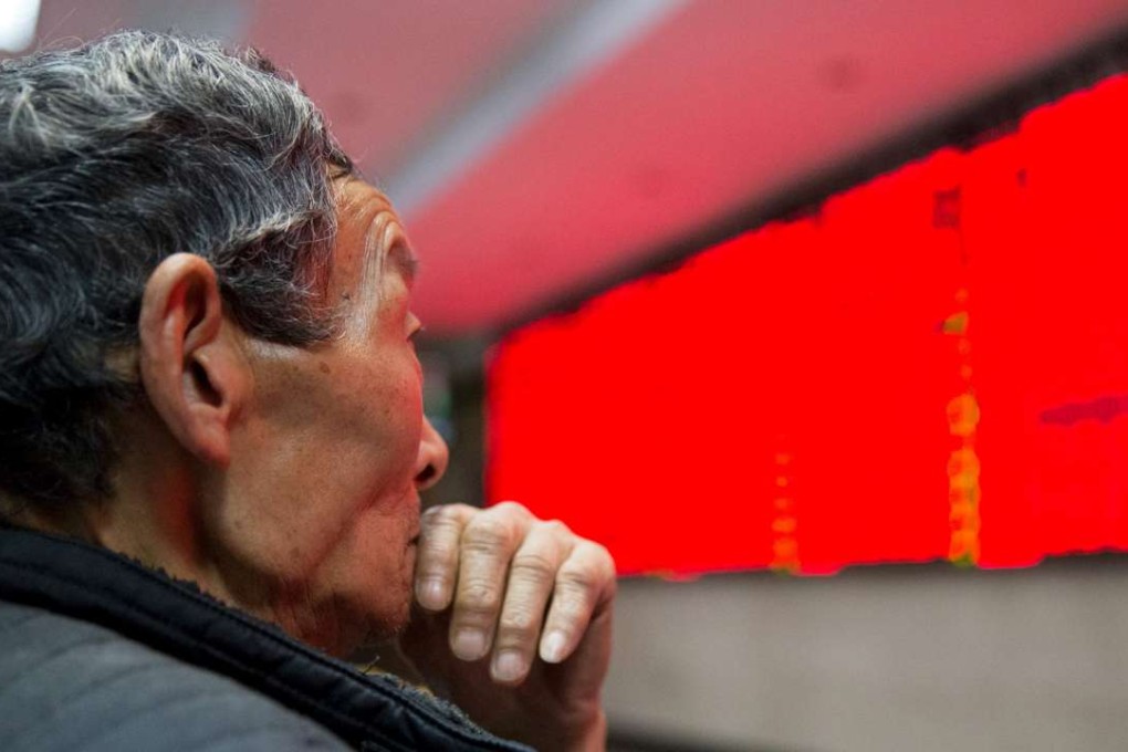 An investor looks at an electronic screen showing stock information at a brokerage house in Nanjing, Jiangsu province. Photo: Reuters