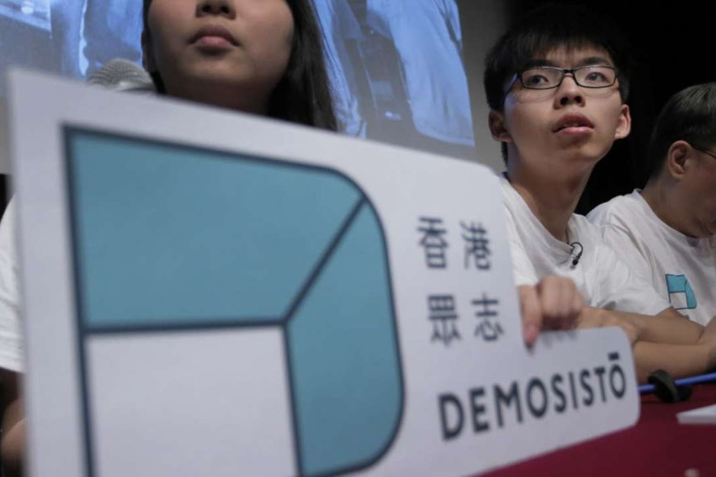 Hong Kong teen activist Joshua Wong (centre) and members of their new political party Demosisto listen to reporter's questions as they officially unveiled during a press conference. Photo: AP