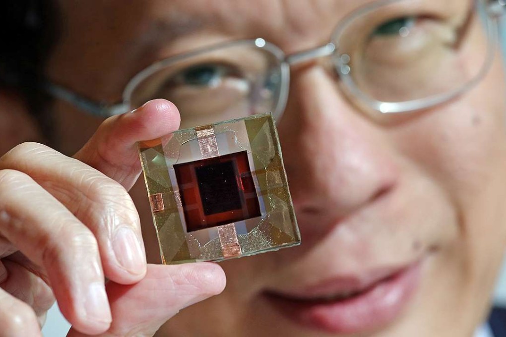 Professor Charles Chee Surya with the perovskite-silicon tandem solar cells, which he claims have the world's highest power conversion efficiency. Photo: K.Y. Cheng